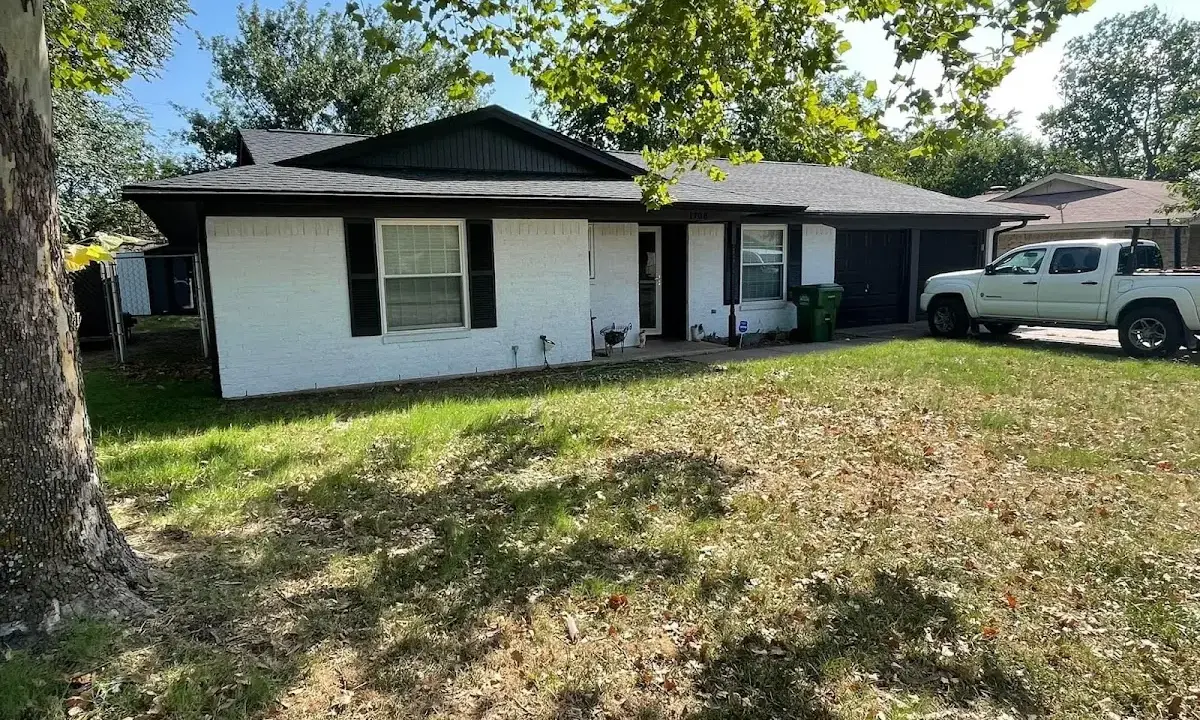 Professional roofing crew working on a residential roof in Deming